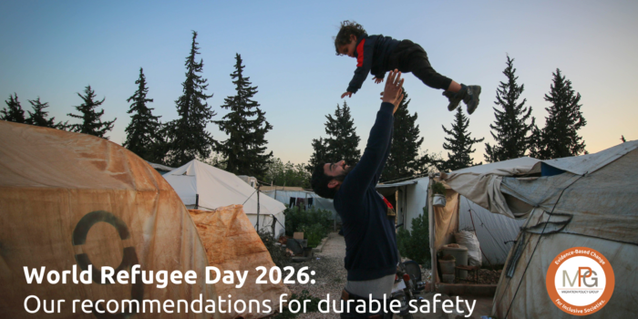 A father playfully throws his young child up in the air in a refugee camp.