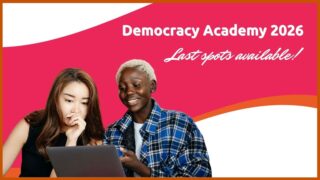 The photos of two young women working together on a laptop in an engaged manner, with the hot pink and orange colors of the academy behind them and the words "Democracy Academy 2026" and "Last spots available" superimposed on the right side.
